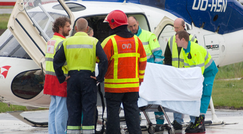 Hulpverleners rondom het slachtoffer bij de traumahelikopter.