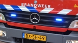 Touringcar in brand op parking Kloosterzande